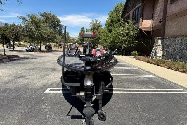 Slide: The Image of 2026 Nitro Z21 XL Pro boat parked in a sunny lot near a building. - 5