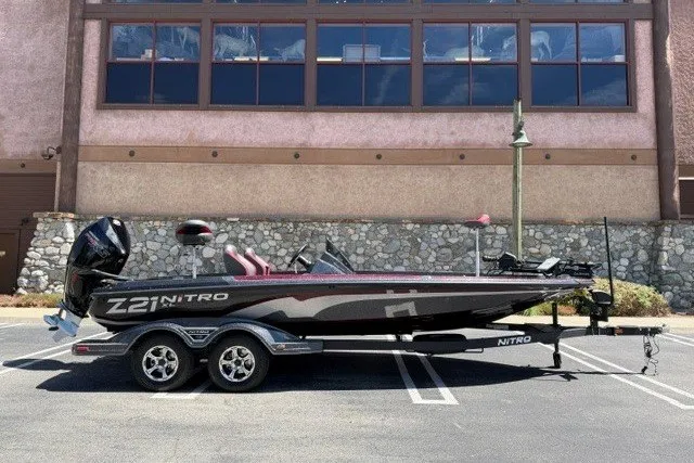 The Image of 2026 Nitro Z21 XL Pro boat on trailer, parked outdoors, side view. - 0