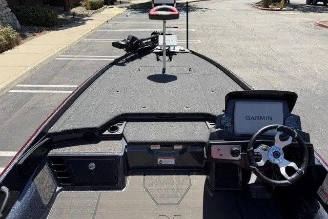 Slide: The Image of 2026 Nitro Z21 XL Pro boat with Garmin navigation system, parked in a lot. - 7