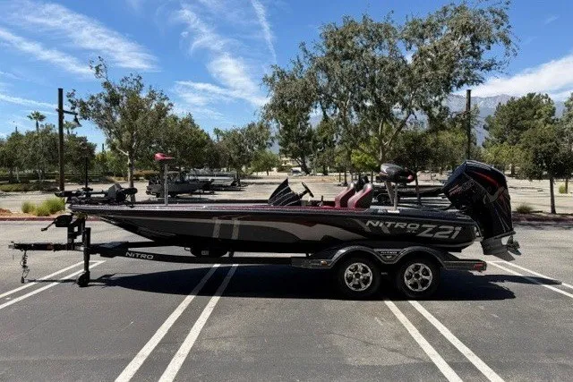 Slide: The Image of 2026 Nitro Z21 XL Pro boat parked in a sunny lot with trees in the background. - 1