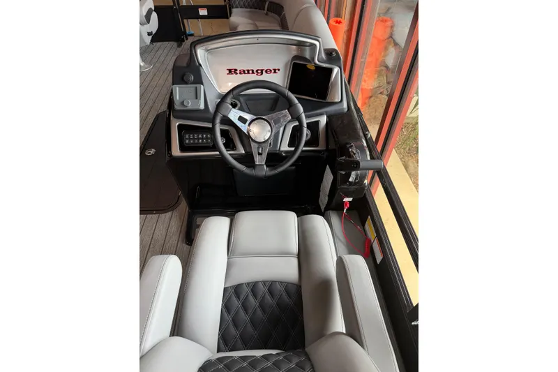 Slide: The Image of 2026 Ranger 223FC boat interior with steering wheel and luxurious seating. - 6