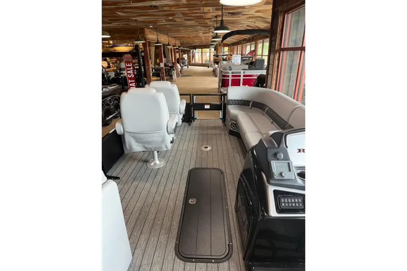 Slide: The Image of 2026 Ranger 223FC boat interior with seating and control panel in showroom. - 5