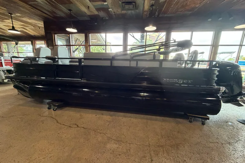 Slide: The Image of 2026 Ranger 223FC pontoon boat displayed indoors with modern seating. - 7