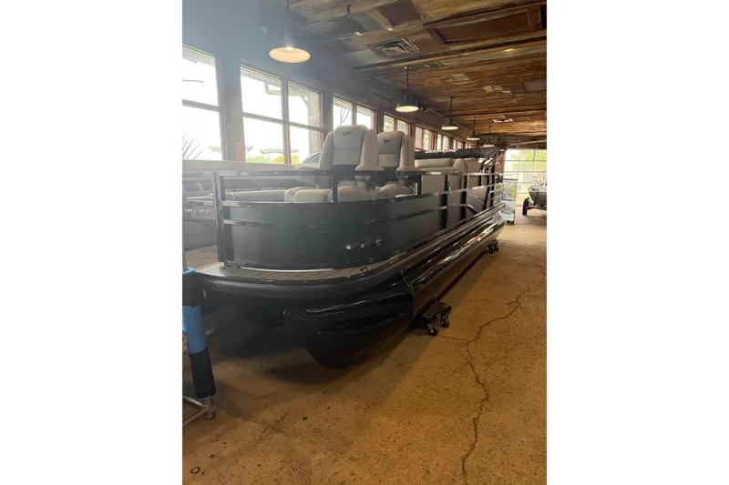 Slide: The Image of 2026 Ranger 223FC pontoon boat displayed indoors with seating and sleek design. - 8