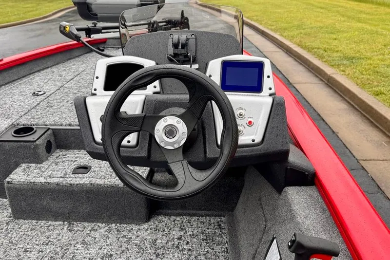 Slide: The Image of 2026 Tracker Pro Team 175 boat dashboard with steering wheel and control panel. - 10
