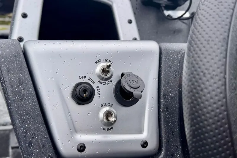 Slide: The Image of Control panel of 2026 Tracker Pro Team 175 boat with switches and 12V outlet. - 13