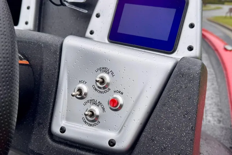 Slide: The Image of Control panel of 2026 Tracker Pro Team 175 boat with switches and display screen. - 12
