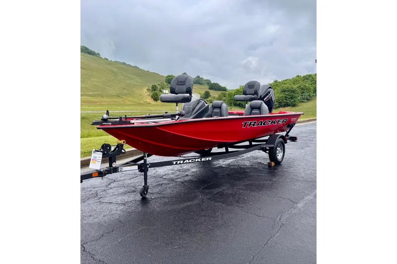 Slide: The Image of 2026 Tracker Pro Team 175 boat in vibrant red on a trailer, parked on a paved road. - 3