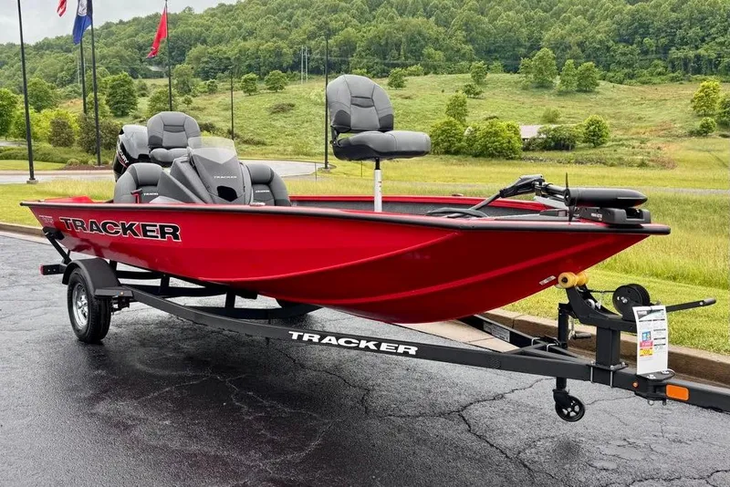 Slide: The Image of 2026 Tracker Pro Team 175 boat in vibrant red on a trailer, set against a lush green landscape. - 2
