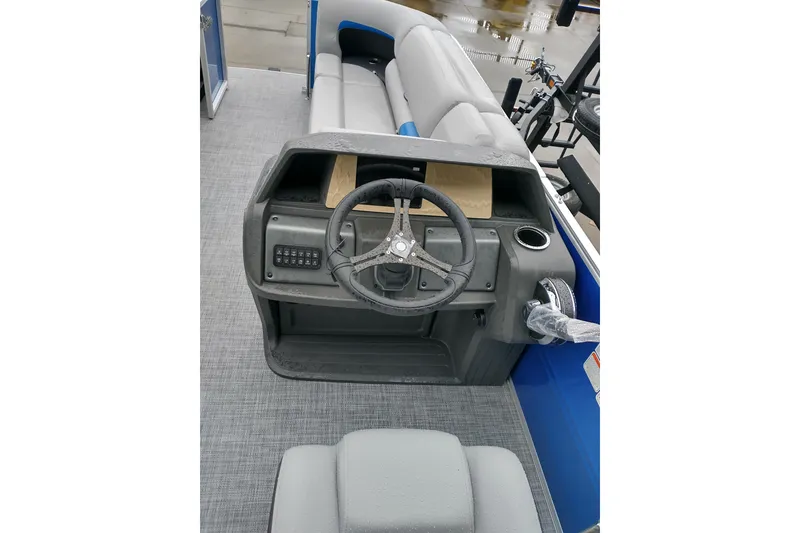 Slide: The Image of 2026 Sun Tracker Party Barge 20 DLX interior with steering wheel and seating. - 6