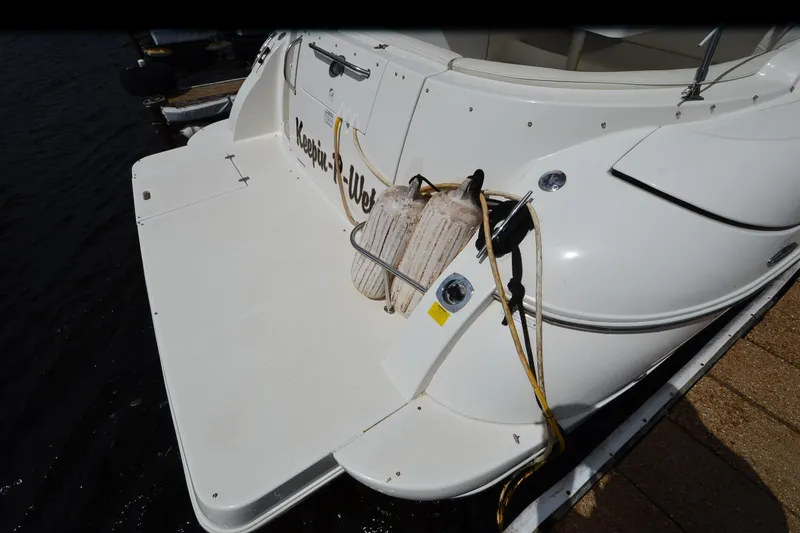 Slide: The Image of 2004 Cruisers Yachts 340 Express boat stern with fenders and dock lines. - 10