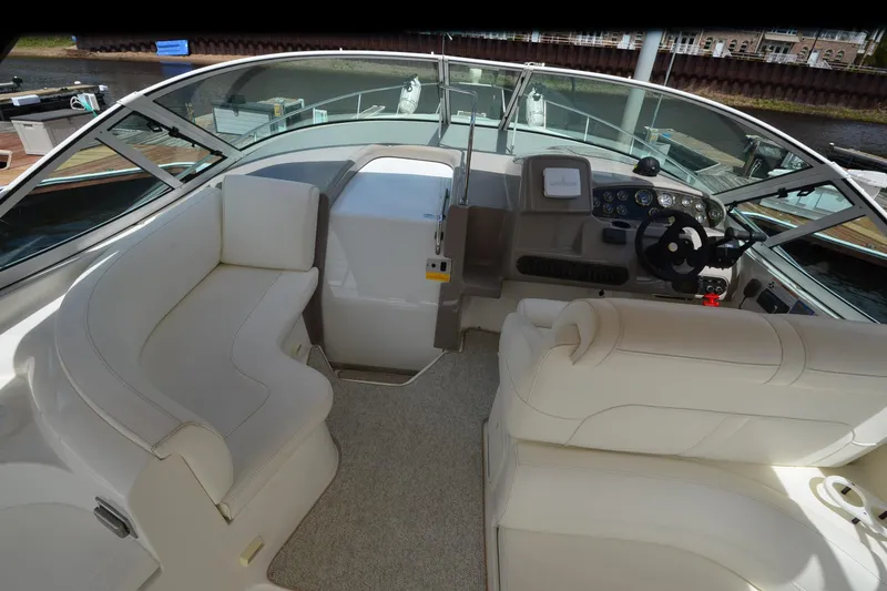 Slide: The Image of 2004 Cruisers Yachts 340 Express cockpit with plush seating and modern controls. - 12