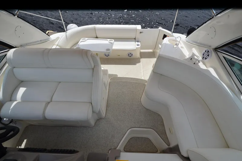 Slide: The Image of 2004 Cruisers Yachts 340 Express interior with white seating and spacious layout. - 16
