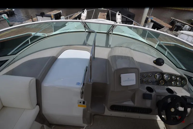 Slide: The Image of 2004 Cruisers Yachts 340 Express helm with steering wheel and control panel. - 18