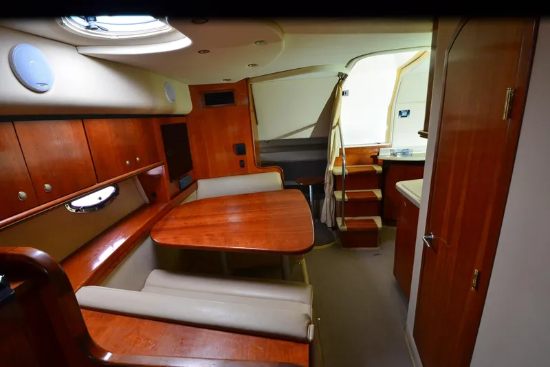 Slide: The Image of Luxurious interior of 2004 Cruisers Yachts 340 Express with wood finishes and seating area. - 19