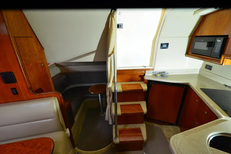 Slide: The Image of Interior of 2004 Cruisers Yachts 340 Express with kitchenette and seating area. - 20