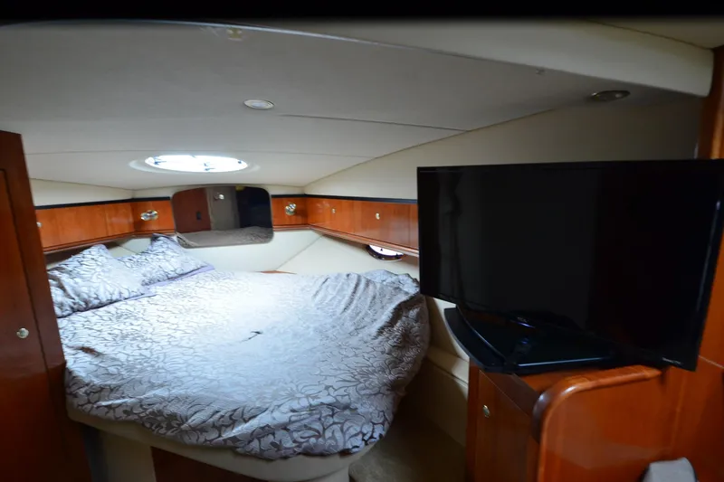 Slide: The Image of Luxurious cabin interior of 2004 Cruisers Yachts 340 Express with bed and TV. - 25