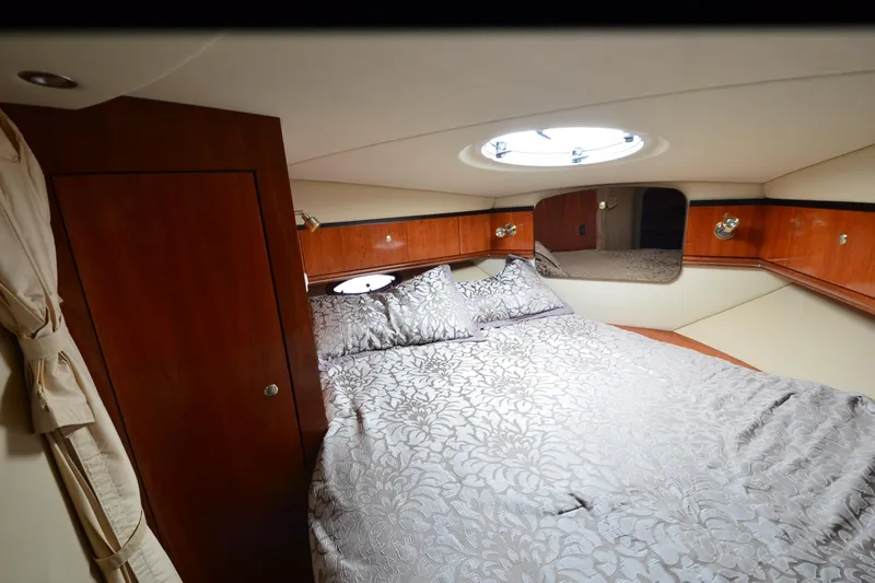 Slide: The Image of Luxurious cabin interior of 2004 Cruisers Yachts 340 Express with elegant bedding. - 26