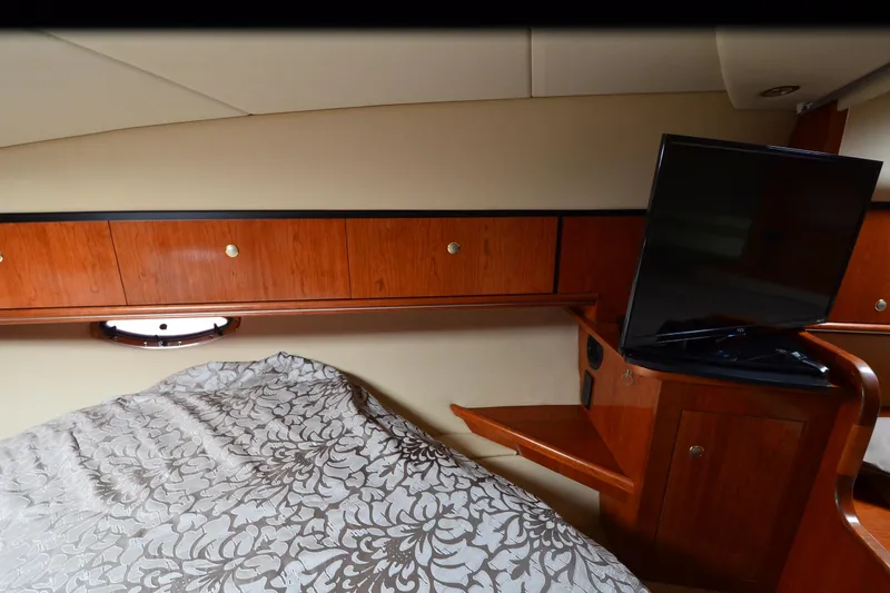 Slide: The Image of Luxurious cabin interior of 2004 Cruisers Yachts 340 Express with TV and wood cabinetry. - 28