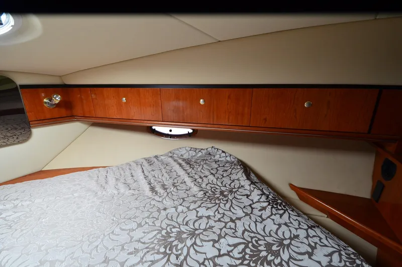 Slide: The Image of Luxurious cabin interior of 2004 Cruisers Yachts 340 Express with elegant wood cabinetry. - 29