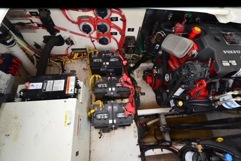Slide: The Image of Engine compartment of 2004 Cruisers Yachts 340 Express with Volvo engine and battery setup. - 36