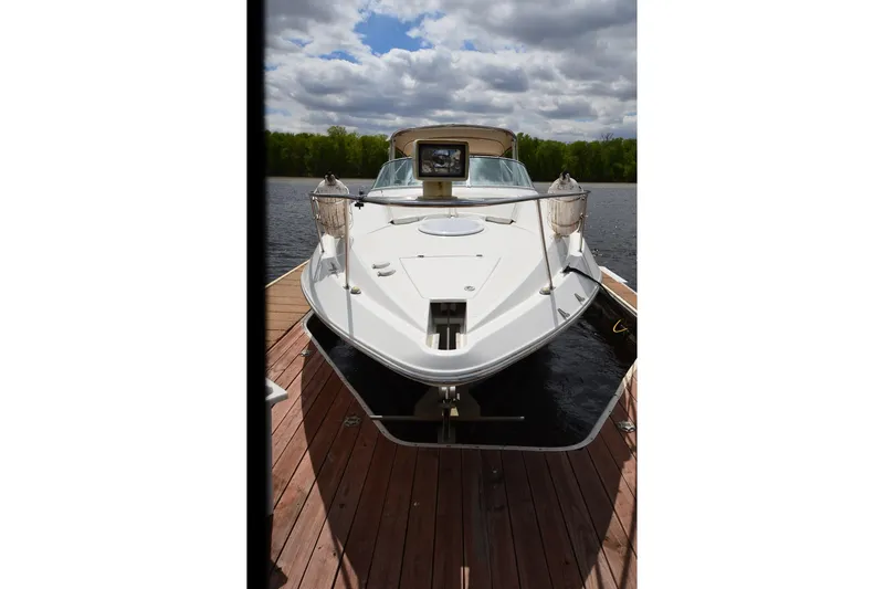 Slide: The Image of 2004 Cruisers Yachts 340 Express docked on a sunny day with cloudy sky. - 7