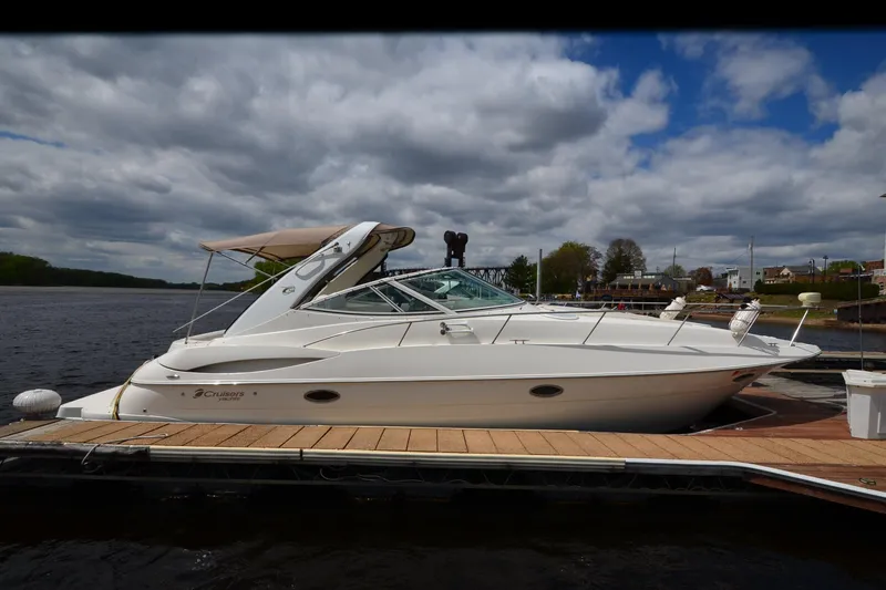 Slide: The Image of 2004 Cruisers Yachts 340 Express docked on a calm river under cloudy skies. - 8