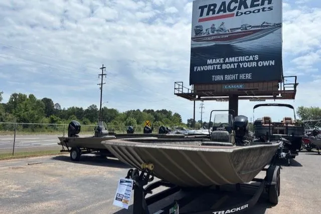 The Image of 2026 Tracker Grizzly 2072 CC boat displayed outdoors under a Tracker Boats billboard. - 0