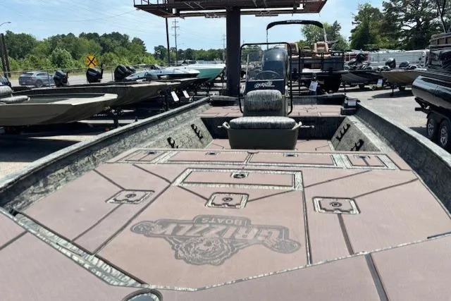 Slide: The Image of 2026 Tracker Grizzly 2072 CC boat with spacious deck, parked outdoors. - 10