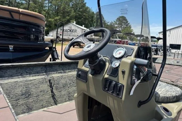 Slide: The Image of 2026 Tracker Grizzly 2072 CC boat dashboard with steering wheel and gauges. - 15