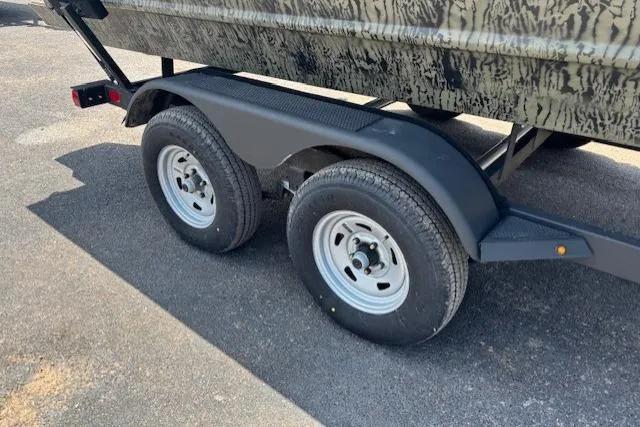 Slide: The Image of Trailer wheels of a 2026 Tracker Grizzly 2072 CC boat on pavement. - 18