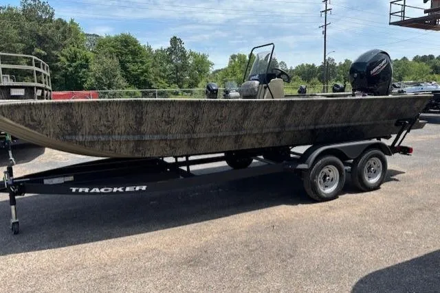 Slide: The Image of 2026 Tracker Grizzly 2072 CC boat on trailer, parked outdoors. - 2