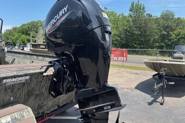 Slide: The Image of 2026 Tracker Grizzly 2072 CC boat with Mercury outboard motor in a sunny outdoor setting. - 4