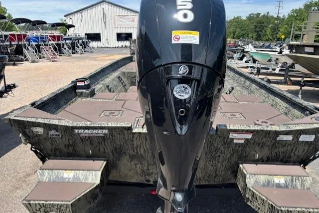 Slide: The Image of 2026 Tracker Grizzly 2072 CC boat with powerful outboard motor in a marina setting. - 5