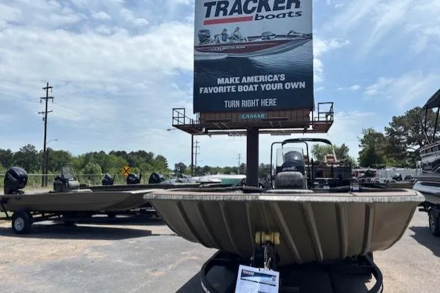 Slide: The Image of 2026 Tracker Grizzly 2072 CC boat displayed outdoors under a Tracker Boats sign. - 9