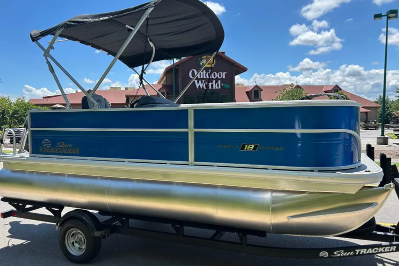 Slide: The Image of 2026 Sun Tracker Party Barge 18 DLX pontoon boat displayed outdoors under a clear sky. - 3