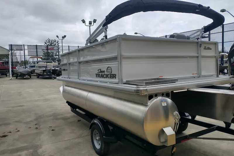Slide: The Image of 2026 Sun Tracker Party Barge 16 DLX pontoon boat on trailer in dealership lot. - 3