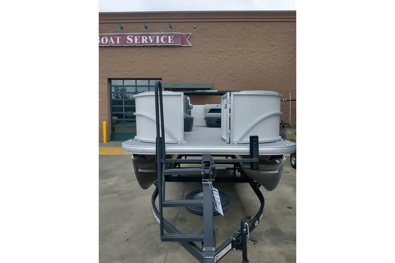 Slide: The Image of 2026 Sun Tracker Party Barge 16 DLX pontoon boat at a boat service center. - 5