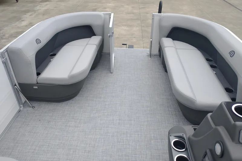 Slide: The Image of 2026 Sun Tracker Party Barge 16 DLX interior with gray seating and cup holders. - 9