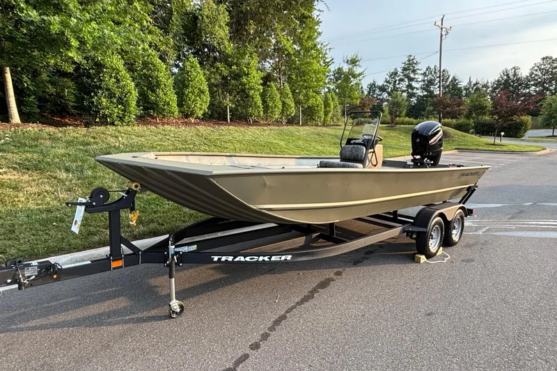 Slide: The Image of 2026 Tracker Grizzly 2072 CC boat on trailer, parked on a road near greenery. - 2