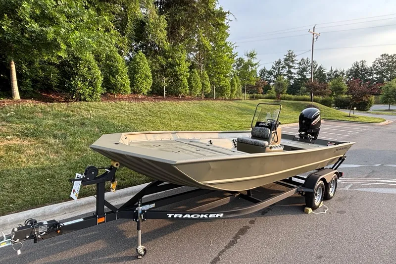 Slide: The Image of 2026 Tracker Grizzly 2072 CC boat on trailer in a parking lot. - 3