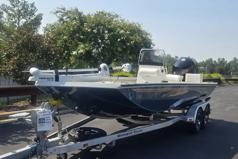 The Image of 2026 Ranger RT178 boat on trailer, parked outdoors, featuring Minn Kota trolling motor. - 0