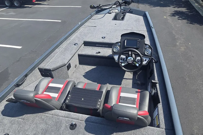 Slide: The Image of 2026 Ranger RT178 boat interior with steering console and seating, parked on asphalt. - 1