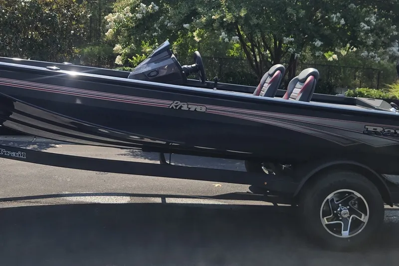 Slide: The Image of 2026 Ranger RT178 boat on trailer, parked outdoors with lush greenery background. - 3