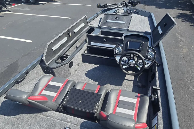 Slide: The Image of 2026 Ranger RT178 boat interior with steering wheel, storage compartments, and seating. - 2
