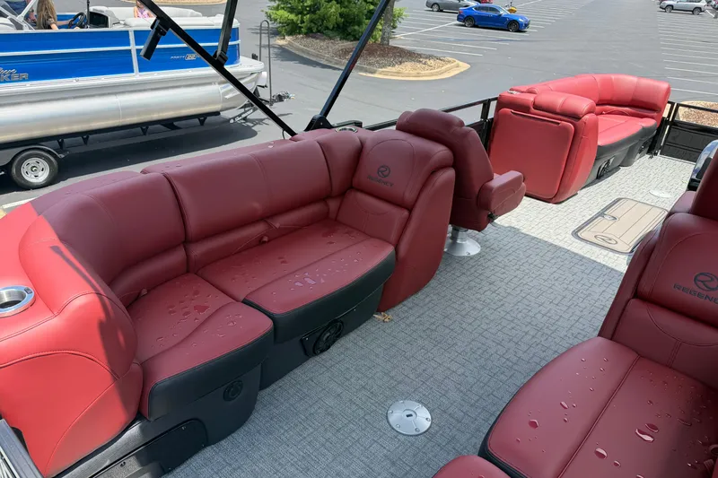 Slide: The Image of Luxurious 2026 Regency 230 DL pontoon boat with red leather seating and spacious deck. - 9