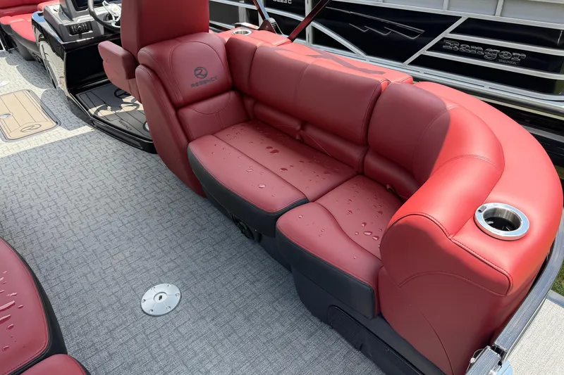 Slide: The Image of Red leather seating on 2026 Regency 230 DL boat, featuring cup holders and modern design. - 10