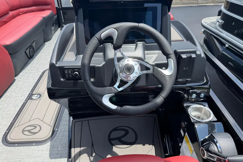 Slide: The Image of Steering console of 2026 Regency 230 DL boat with modern design and red seating. - 5