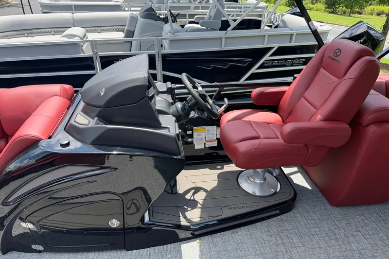 Slide: The Image of Luxurious 2026 Regency 230 DL boat interior with red captain's chair and sleek dashboard. - 6
