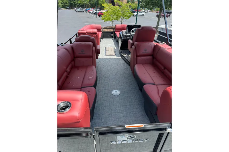 Slide: The Image of 2026 Regency 230 DL pontoon boat with luxurious red seating and spacious interior. - 11